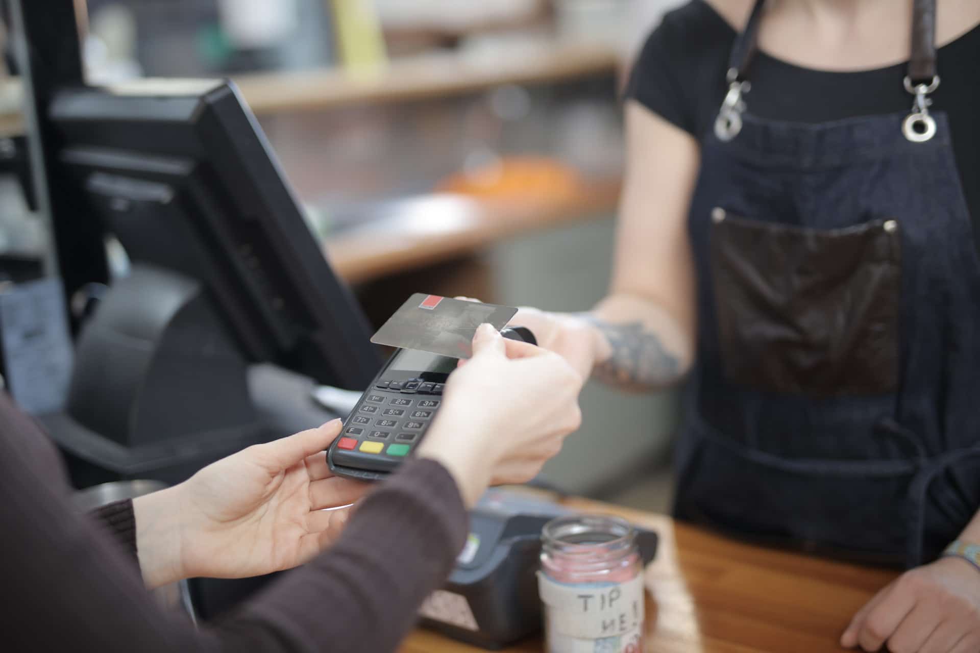 Image of cashier performing age verification.