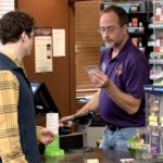 Image of cashier performing age verification