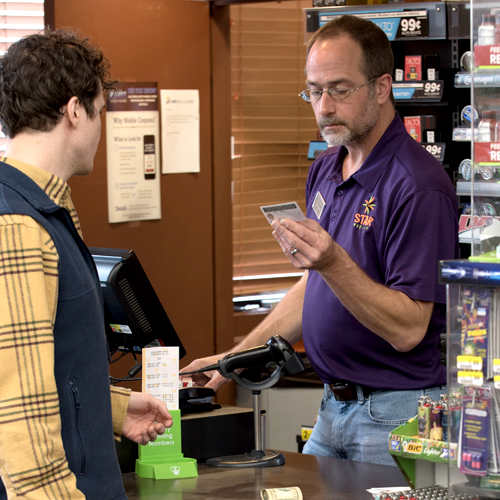 Image of cashier performing age verification