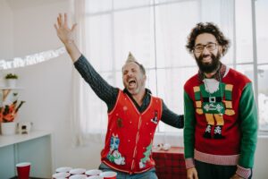 Image of fun loving staff participating in holiday sweater contest. Store managers impact team building. Store manager ROI strategy involves three components: chain impact, store operations and chain support. Some of the more obvious items that are considered that impact investment returns include the ability to increase store sales and improve store operations.