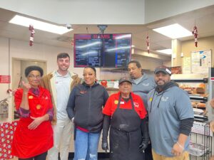 Rams convenience store team with Operations Manager Dylan Conley celebrating teamwork and operational excellence.