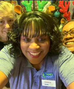 Convenience store manager celebrating the holidays with her team